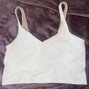 white lululemon lightweight cropped top.